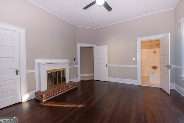 unfurnished living room featuring ceiling fan, ornamental molding, a brick fireplace, and dark hardwood / wood-style floors