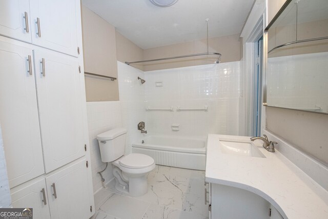 full bathroom with vanity, toilet, tile walls, and shower / bathtub combination