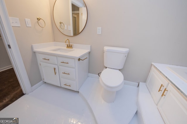 bathroom with toilet and vanity