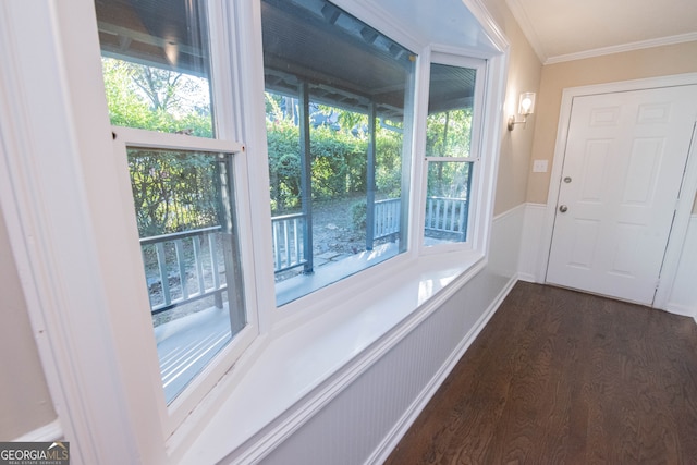 entryway with crown molding, dark hardwood / wood-style floors, and a healthy amount of sunlight