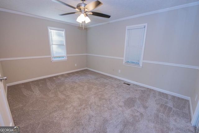 carpeted spare room with crown molding and ceiling fan