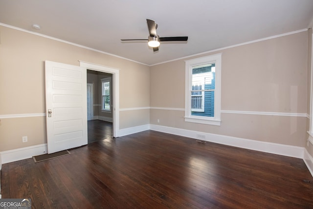 empty room with ornamental molding, ceiling fan, and dark hardwood / wood-style flooring