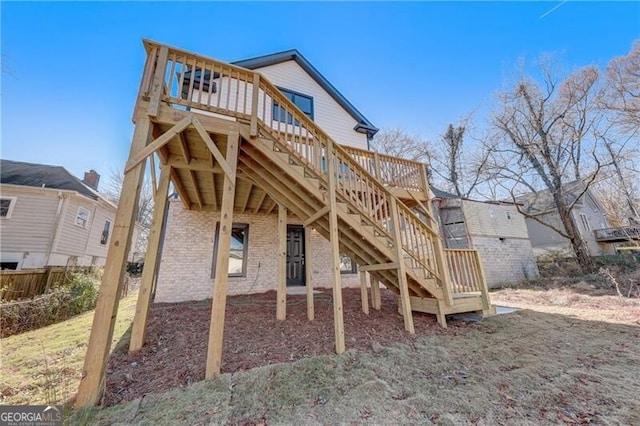 back of property featuring a wooden deck