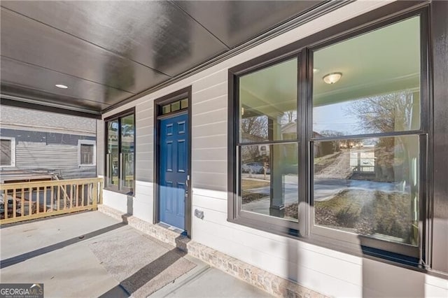 view of exterior entry with covered porch