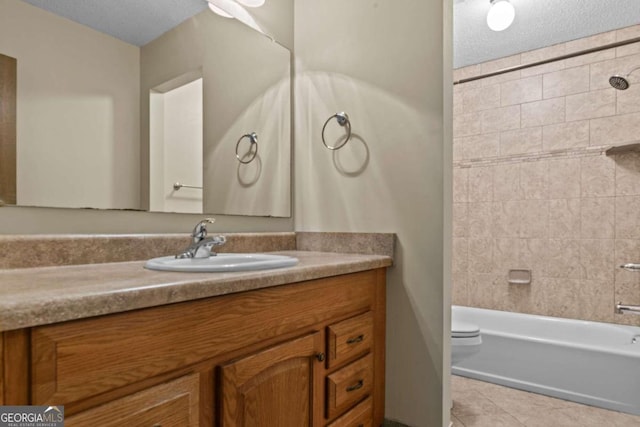 bathroom with vanity, toilet, a textured ceiling, tile patterned floors, and  shower combination