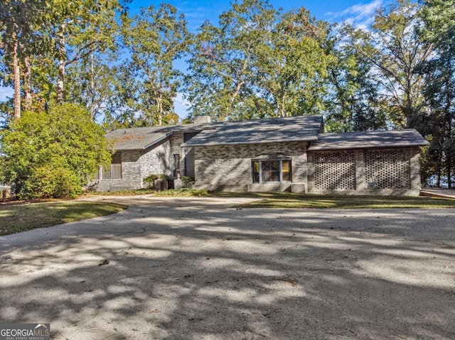 mid-century home featuring brick siding
