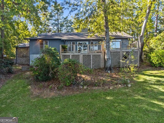 back of house with a yard and a wooden deck