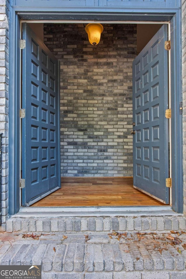 view of exterior entry with brick siding