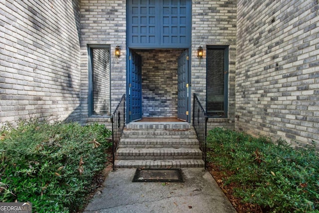 view of exterior entry with brick siding