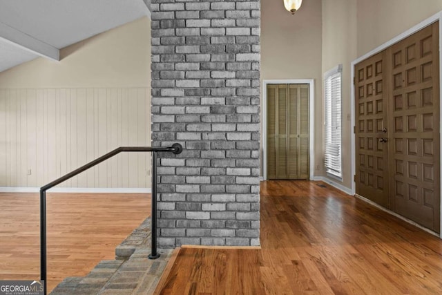 entryway with baseboards, wood finished floors, and a heating unit
