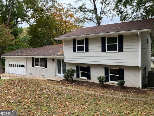 3666 Elkridge Dr, Decatur, GA 30032 - split level home with brick siding, an attached garage, central AC, and roof with shingles