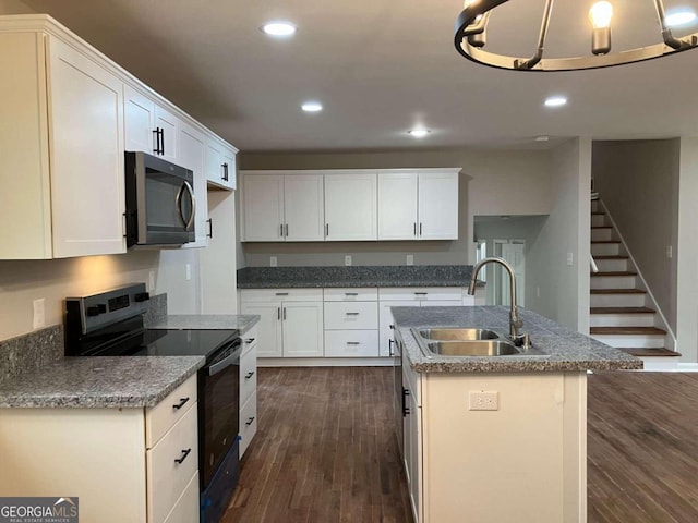 3666 Elkridge Dr, Decatur, GA 30032 - kitchen featuring dark wood-style flooring, range with electric stovetop, recessed lighting, stainless steel microwave, and a sink