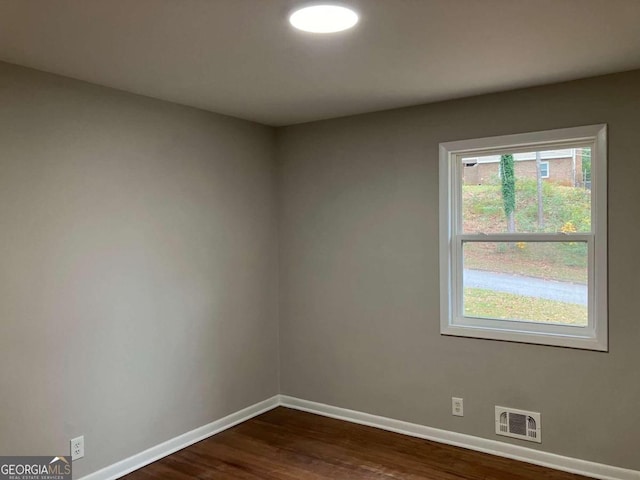 spare room with dark hardwood / wood-style flooring