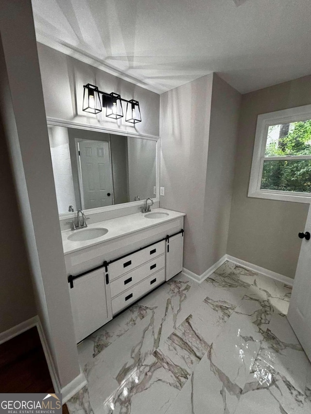 3666 Elkridge Dr, Decatur, GA 30032 - full bathroom featuring double vanity, a sink, marble finish floor, and baseboards