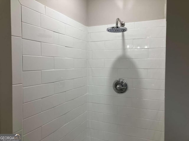 interior details with a tile shower