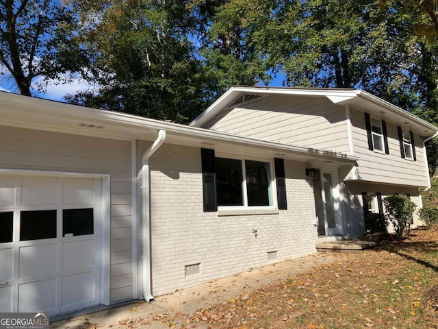 3666 Elkridge Dr, Decatur, GA 30032 - tri-level home featuring an attached garage, brick siding, and crawl space