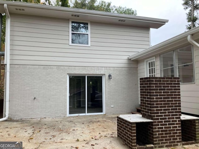 3666 Elkridge Dr, Decatur, GA 30032 - back of property with brick siding and a patio