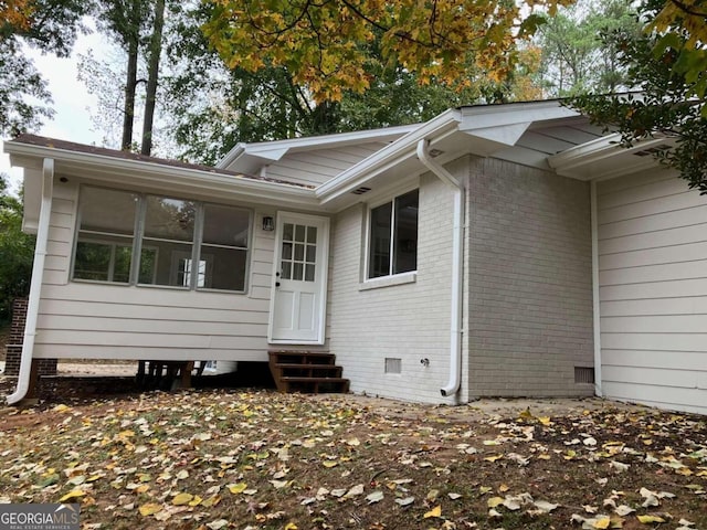 rear view of house with a sunroom