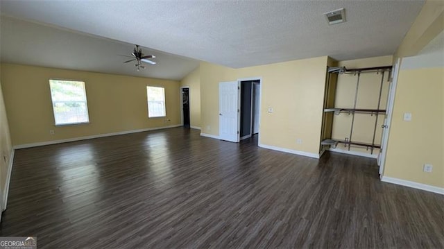 unfurnished living room featuring a textured ceiling, dark hardwood / wood-style floors, and ceiling fan