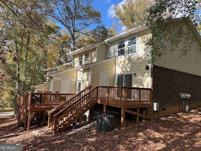 rear view of property featuring a deck and central AC unit