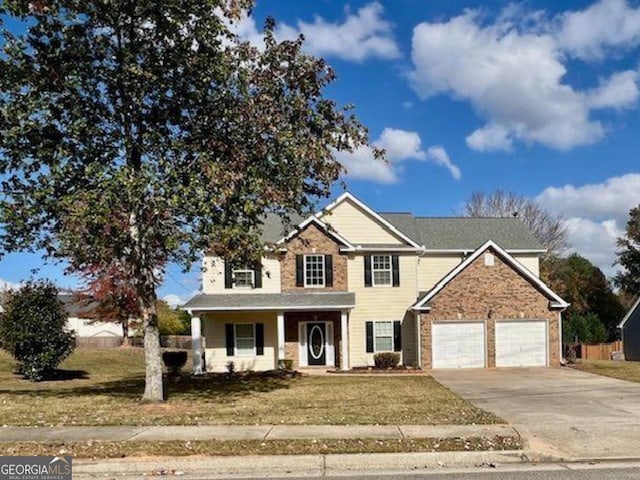 view of front of house featuring covered porch and a front yard