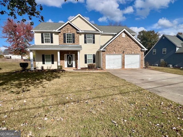 view of front of house featuring a front yard and a garage