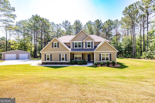 craftsman inspired home with a front yard, an outbuilding, and a garage