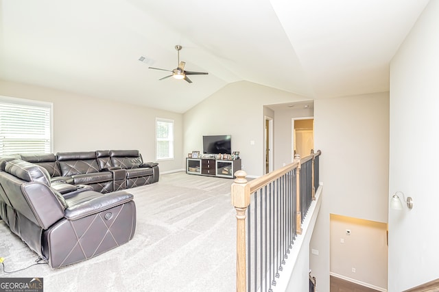 living room with vaulted ceiling, ceiling fan, carpet flooring, and plenty of natural light