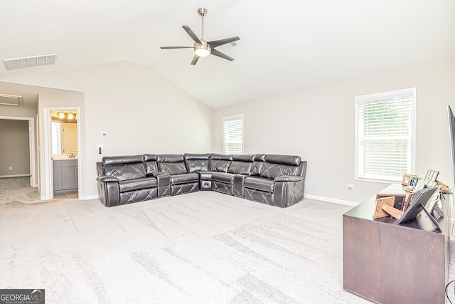 living room with light carpet, ceiling fan, and vaulted ceiling