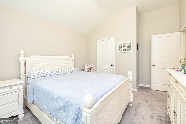 bedroom with light colored carpet and vaulted ceiling