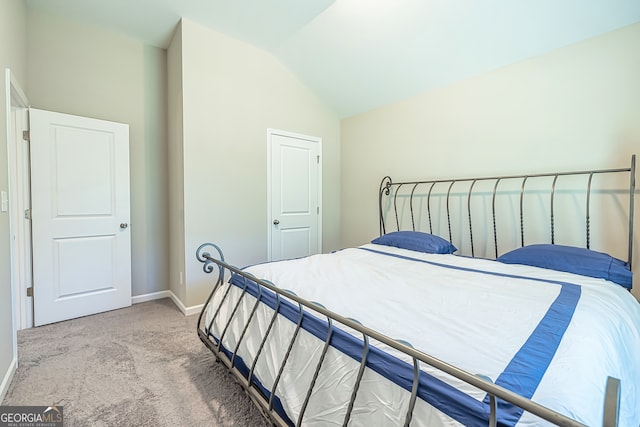 carpeted bedroom featuring lofted ceiling