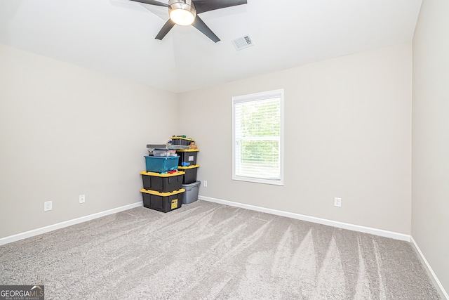 interior space with carpet flooring and ceiling fan