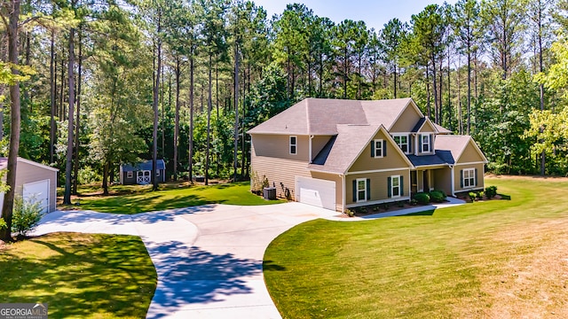 view of front of property featuring a front lawn, central AC unit, and a garage