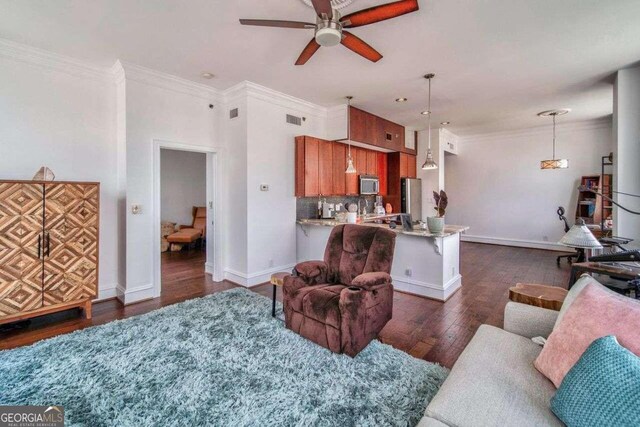 living room with ornamental molding, ceiling fan, and dark hardwood / wood-style flooring