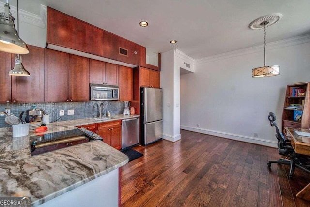 kitchen featuring tasteful backsplash, sink, stainless steel appliances, decorative light fixtures, and dark hardwood / wood-style floors