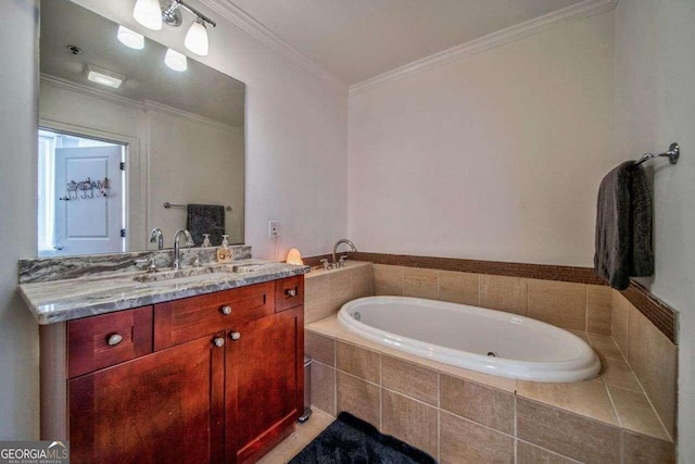 bathroom with vanity, crown molding, and tiled bath