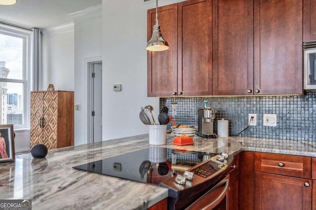 kitchen with ornamental molding, light stone counters, black range, and backsplash