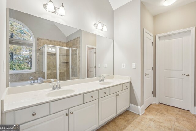 bathroom with vanity, lofted ceiling, separate shower and tub, and tile patterned flooring