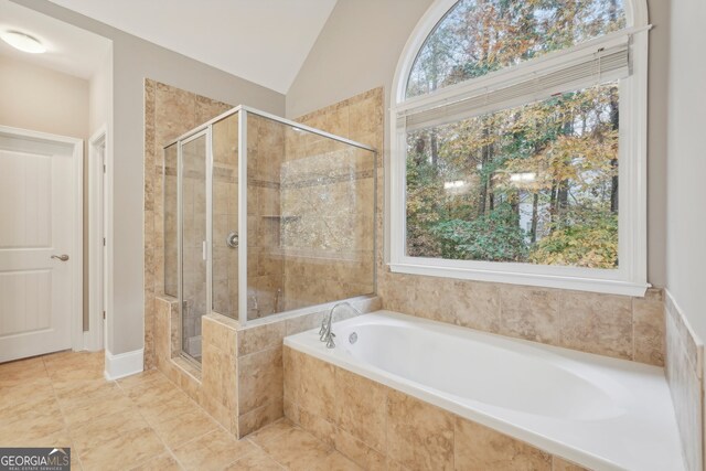 bathroom featuring vaulted ceiling and plus walk in shower