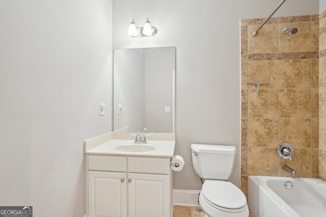 full bathroom featuring toilet, tiled shower / bath, vanity, and tile patterned floors