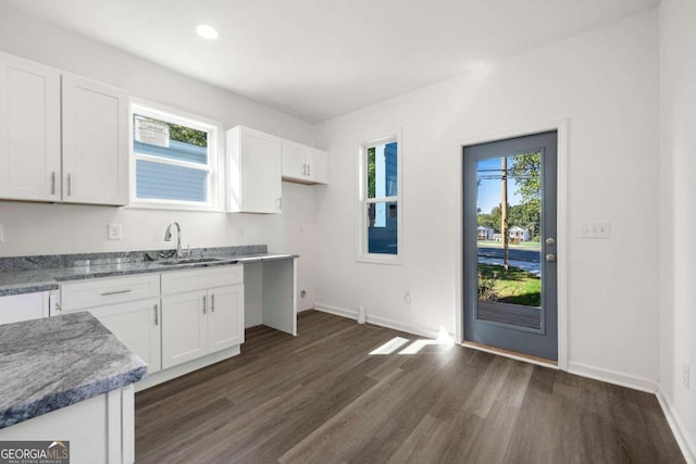 kitchen featuring white cabinets, dark wood-type flooring, and a healthy amount of sunlight