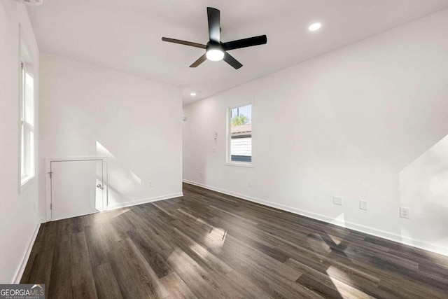 empty room with ceiling fan and dark hardwood / wood-style floors