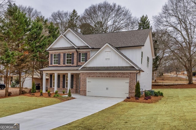 view of front of house featuring covered porch, a front yard, and a garage