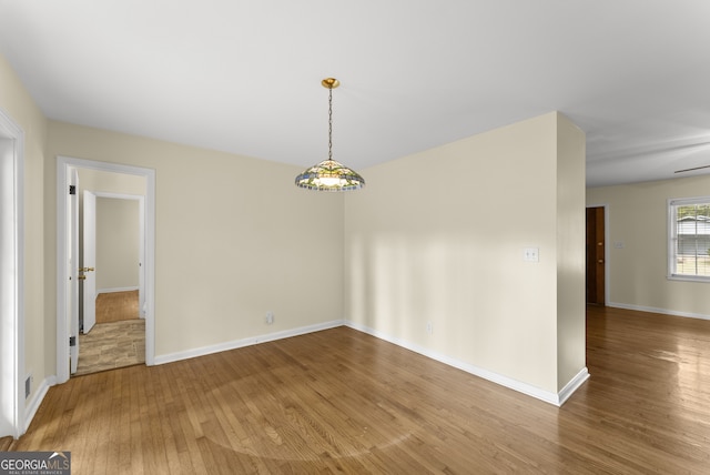 empty room with hardwood / wood-style floors