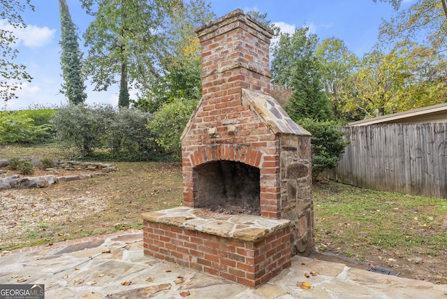 view of patio / terrace featuring an outdoor brick fireplace