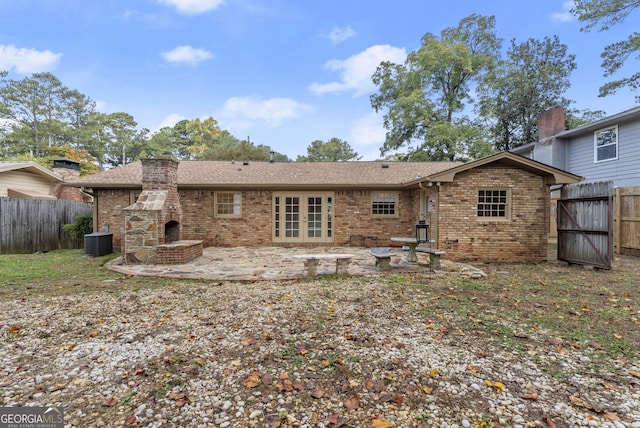 rear view of house with french doors, cooling unit, and a patio area