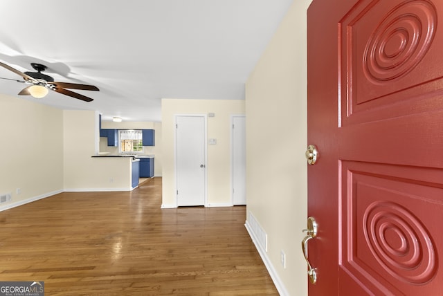 foyer with ceiling fan and hardwood / wood-style floors