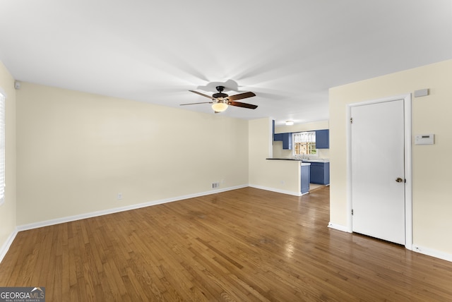 unfurnished living room featuring dark hardwood / wood-style floors and ceiling fan