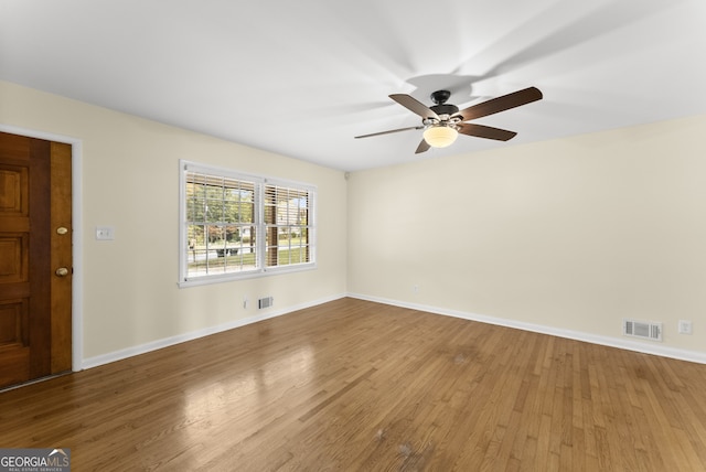 empty room featuring hardwood / wood-style floors and ceiling fan