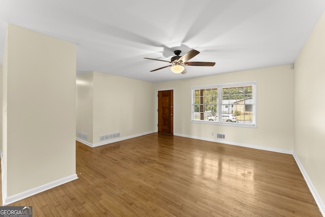 empty room featuring ceiling fan and wood-type flooring